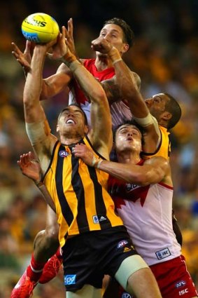 Mike Pyke of the Swans attempts to mark over the top of Max Bailey of the Hawks when the teams met in round seven at the MCG.