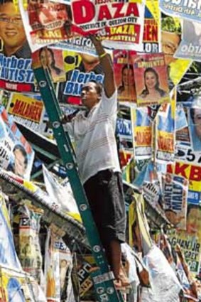 Election posters are taken down in Manila.