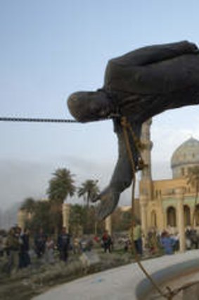 A six-metre-high statue of Saddam Hussein is torn down in central Baghdad.