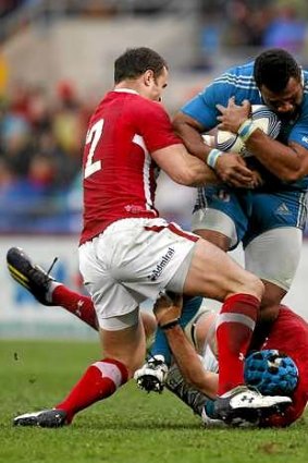 Italy's Manoa Vosawai  is tackled by Jamie Roberts.