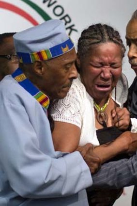 Grief: Eric Garner's wife breaks down during a rally at the National Action Network headquarters.