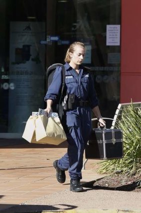 An ACT Policing forensic officer leaves the Canberra International Sports and Aquatic Centre following the death of a girl on Saturday morning.