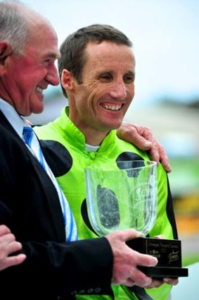 Big day ... Damien Oliver with trainer Leon Corstens after Commanding Jewel’s win in the Thousand Guineas at Caulfield.