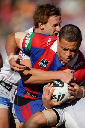 Timana Tahu of the Knights tries to ride a tackle.