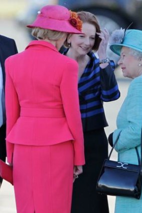 The Queen meets Quentin Bryce and Julia Gillard before being greeted by children.