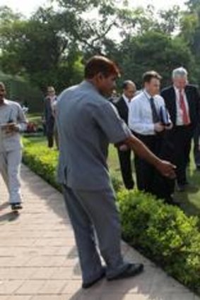 Prime Minister Julia Gillard walks past the spot where she tripped earlier during her official visit to India.