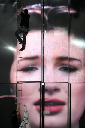 Workers prepare decorations before Russia's entry, Anastasia Prikhodko, rehearses in Moscow.