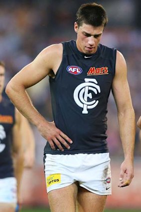 Double trouble: Carlton's Matthew Kreuzer leaves the field after his team's loss to the Magpies.