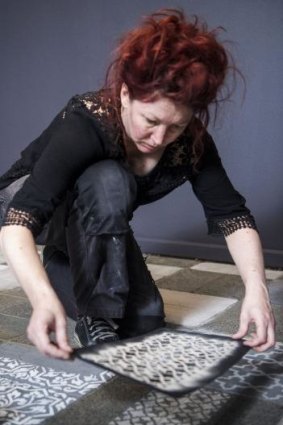 Artist Hannah Bertram prepares her dust installation at La Trobe University Museum of Art.