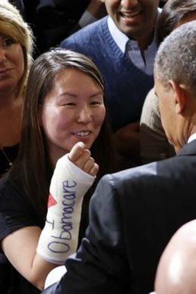 A supporter at an Obamacare event in Boston asks President Obama to sign her cast.