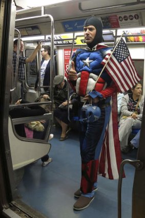 Never sleeps: a man in a costume boards the subway.