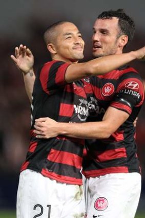 Not a bad start: Shinji Ono and Mark Bridge celebrate winning the Premier's Plate in the Wanderers' inaugural season.