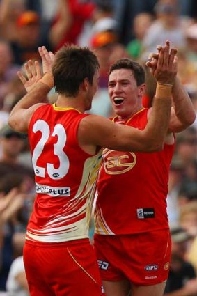 Gold Coast's Charlie Dixon (left) and Danny Stanley celebrate a goal against Richmond at Cazalys Stadium in Cairns.