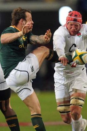 Tom Johnson charges down a kick by Francois Hougaard.
