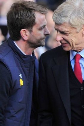Arsenal manager Arsene Wenger (R) shakes hands with his Tottenham counterpart Tim Sherwood.