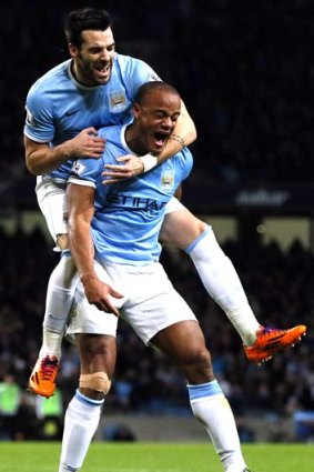 Flying on high: Manchester City's Vincent Kompany celebrates with Alvaro Negredo after scoring a goal against Liverpool during their English Premier League soccer match in December last year.