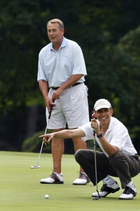 Weekend hackers ... John Boehner and Barack Obama share a laugh on the first green at Joint Base Andrews.