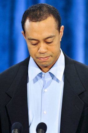 A contrite Tiger Woods pauses as he delivers his media statement.