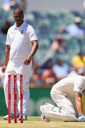Ow zat ...  Michael Clarke falls to the pitch after being hit right between the legs by a delivery from Vernon Philander on the fourth day of the third Test against South Africa.