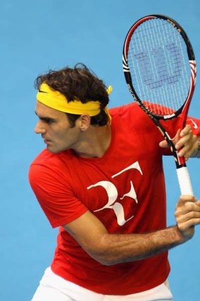 Roger Federer prepares to hit a backhand during a practice session ahead of the 2011 Australian Open at Melbourne Park this afternoon.