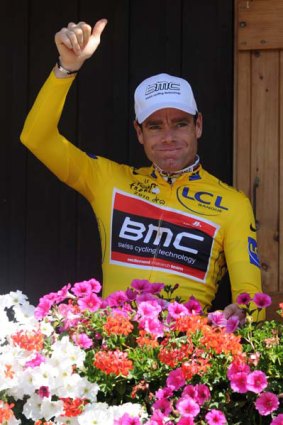 Yellow jersey of overall leader, Australia's Cadel Evans, gives his thumb up as he poses at the hotel hosting the US BMC cycling team.