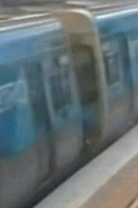A teenager falls on the platform after jumping out of a train.