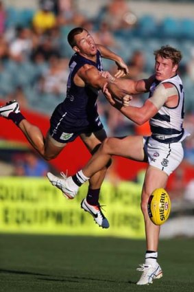 Up in the air: Docker Lee Spurr comes to grips with new Cats recruit Josh Caddy.