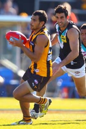 Hawk Cyril Rioli (left) will be assessed this week after injuring a shoulder.