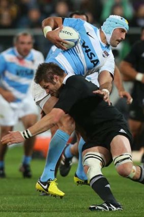 Caught: New Zealand's Richie McCaw lands a tackle during last night's win.