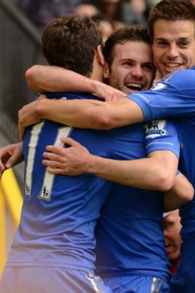 Chelsea's Spanish midfielder Juan Mata (C) celebrates with Cesar Azpilicueta (R) and Oscar (L).