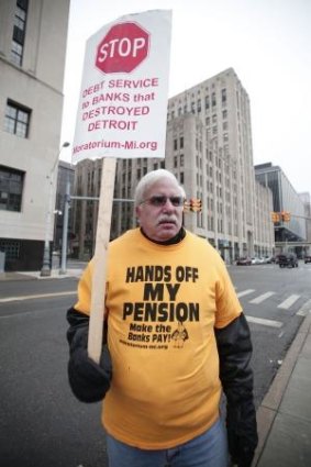 Pensions at risk ... David Sole, a retired City of Detroit Water Department worker, protests outside the US Courthouse, where the bankruptcy verdict was given.