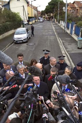 France's French Interior minister Claude Gueant, centre,   speaks to journalists after the raid.