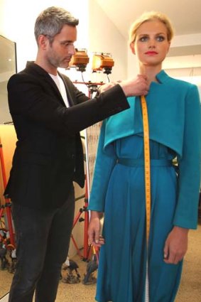 Measuring up ... Carl Kapp can alter garments for customers.