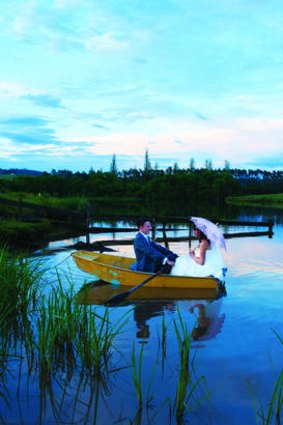 David Rule rows Linda Benton across the dam at their wedding in the Hunter Valley.