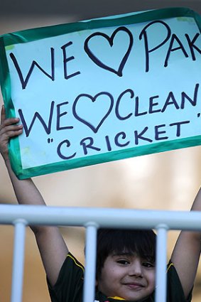 Sign of the times: A young fan holds a placard supporting Pakistan in the third Test against Sri Lanka this week.