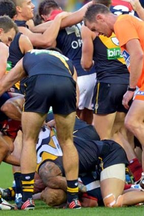 Melbourne runner Andrew Nichol steps on Jake King's foot during a half-time melee.