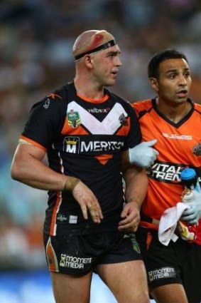 Liam Fulton of the Tigers leaves the field with concussion during round three.