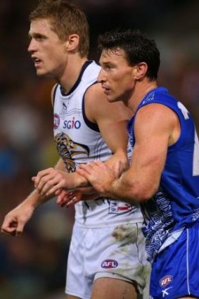 Scott Selwood and Brent Harvey keep a close watch on each other at Patersons Stadium.