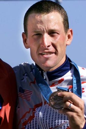 Lance Armstrong poses with his bronze medal after the men's Olympic individual time trial in Sydney, in a September 30, 2000, filephoto.