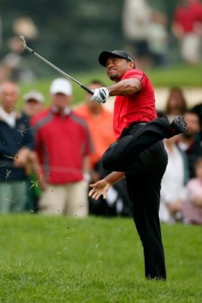 Tiger Woods hits out of the rough on the second hole during the final round of the Bridgestone Invitational.