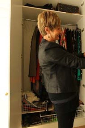 Suzy Black, Personal Shopper and Stylist giving client Carol Turner, 53 a wardrobe make-over in her home. Photo shows a before photo of Suzy on left pulling out items to show Carol.