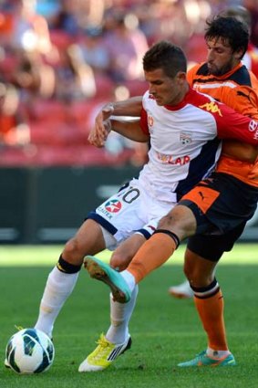Thomas Broich of the Roar was penalised for this challenge on Dario Vidosic of Adelaide.