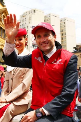 Damien Oliver, who will ride the favourite, waves to the crowd during Monday's Melbourne Cup parade.