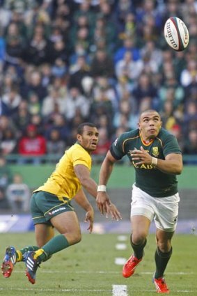 Will Genia looks on as South African winger Bryan Habana runs for the ball during the Rugby Championship match on September 28.
