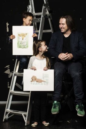 Cartoonist John Shakespeare with Lachlan Gordon and Sienna Burell and the finished versions of their drawings.