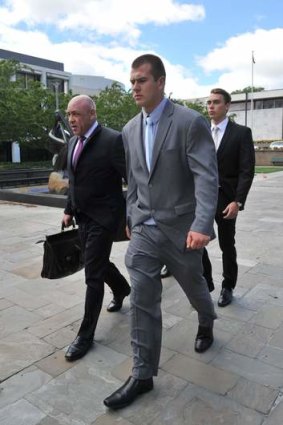 Sacked cadet Daniel McDonald, centre, and Dylan Deblaquiere, rear, leaving the ACT court