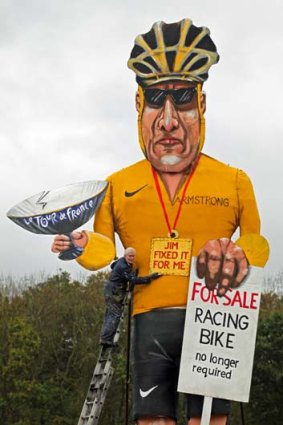 Artist Frank Shepherd with his creation ... US cyclist Lance Armstrong has been unveiled as this year's Edenbridge Bonfire Society celebrity guy.