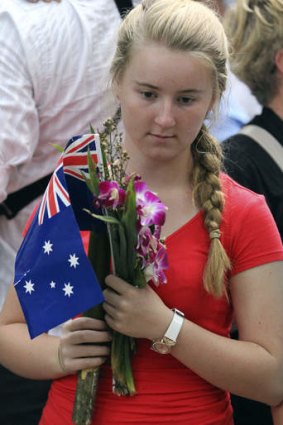 An Australian girl holds a nation flag during the Anzac Day dawn service at Hellfire Pass, western Thailand.