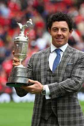 McIlroy poses with the Claret Jug at half-time during the Premier League match between Manchester United and Swansea City last weekend.