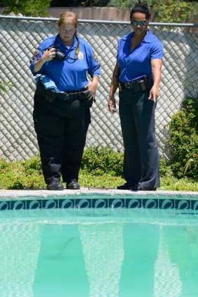 Rialto police photograph the swimming pool where his body was found.